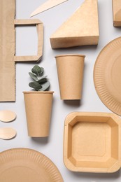 Photo of Flat lay composition with eco friendly food packagings and eucalyptus leaves on light grey background