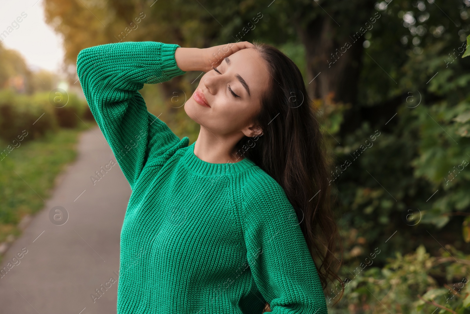 Photo of Beautiful young woman in stylish warm sweater outdoors
