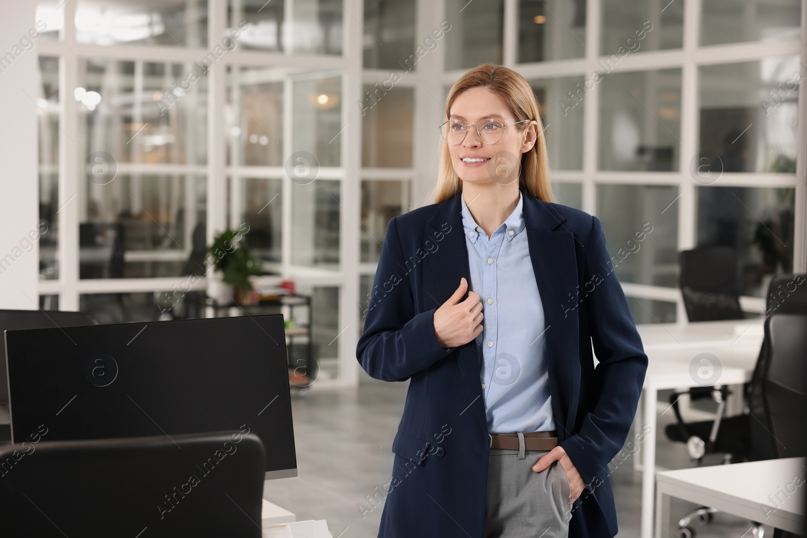 Photo of Happy real estate agent indoors. Space for text