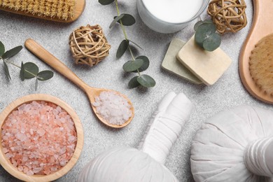 Photo of Flat lay composition with spa products and eucalyptus branches on light grey table