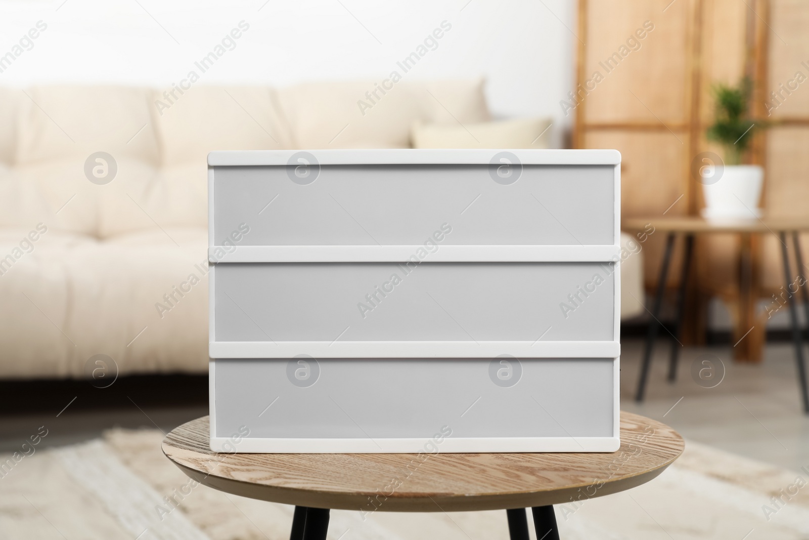 Photo of Blank light board on wooden table indoors