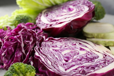 Photo of Different types of cut cabbage on table, closeup