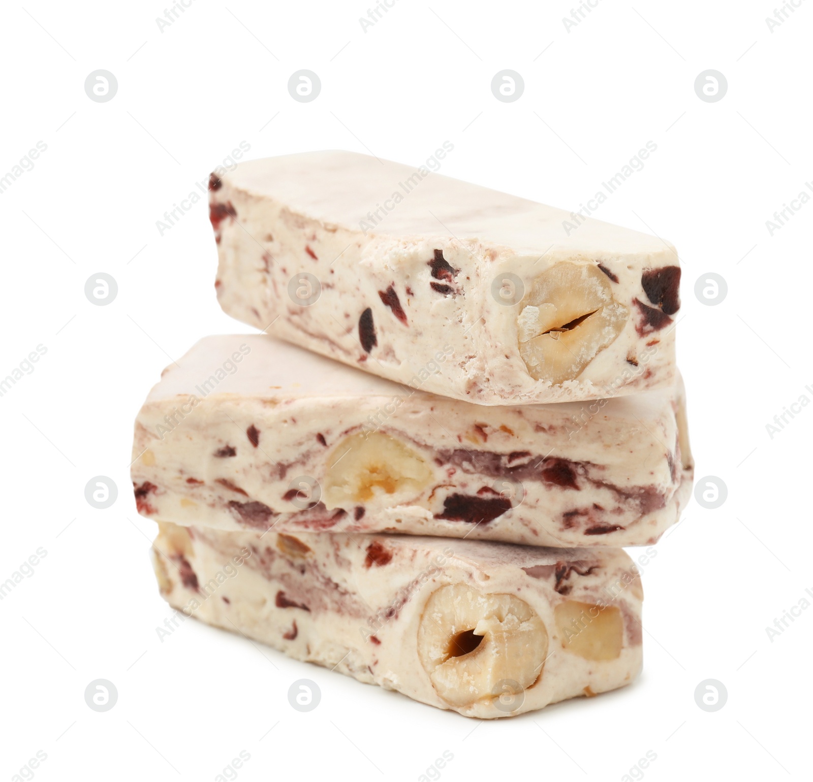 Photo of Pieces of delicious nougat on white background