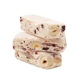 Photo of Pieces of delicious nougat on white background