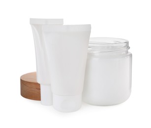 Jar and tubes of hand cream on white background