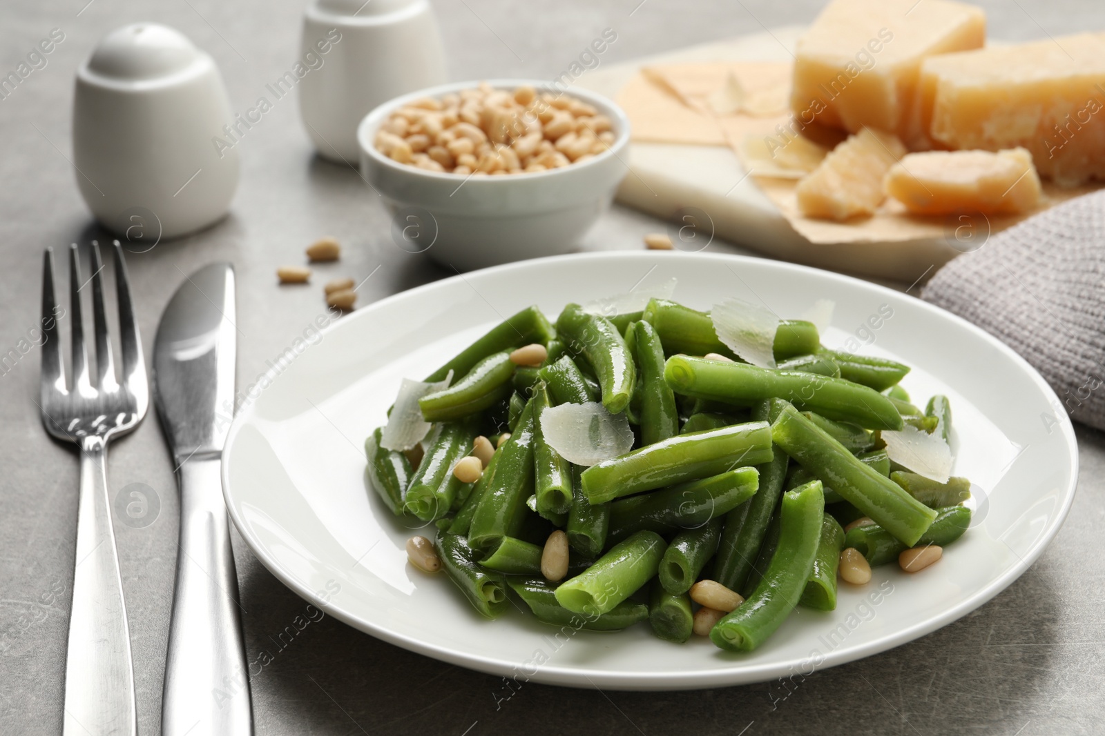 Photo of Tasty salad with green beans served on light grey table