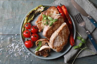 Photo of Delicious grilled meat and vegetables served on wooden table, flat lay