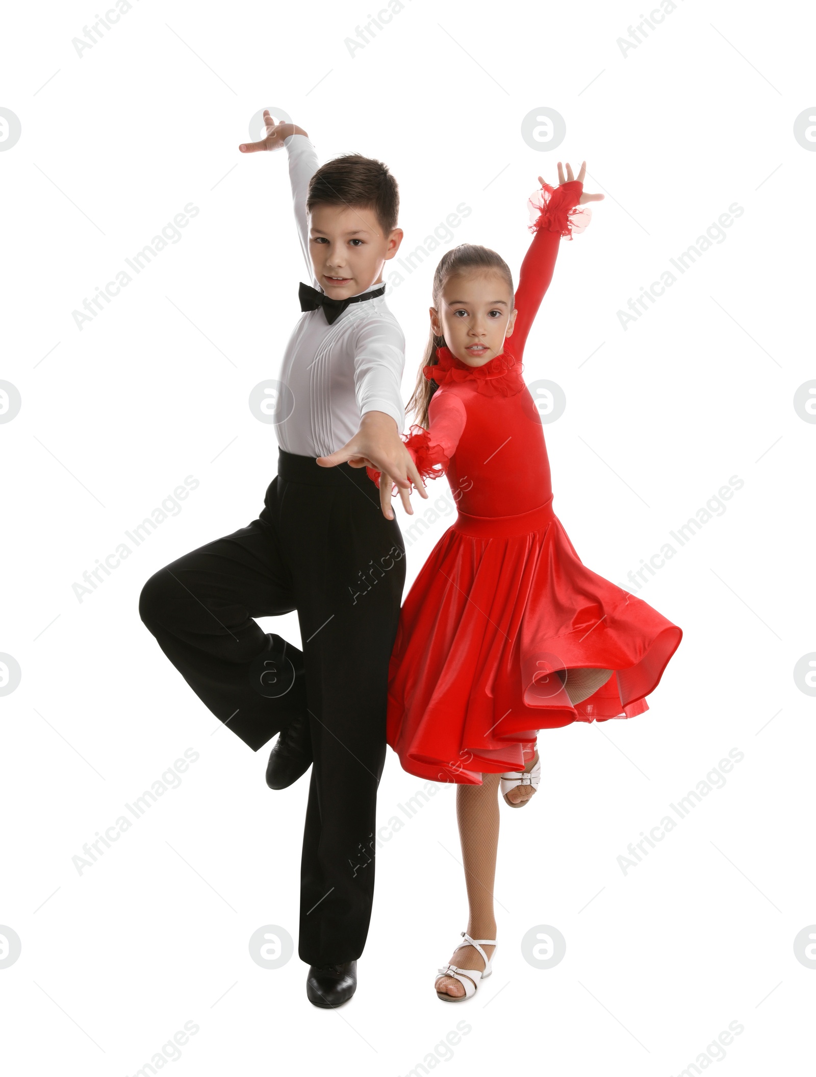 Photo of Beautifully dressed couple of kids dancing on white background