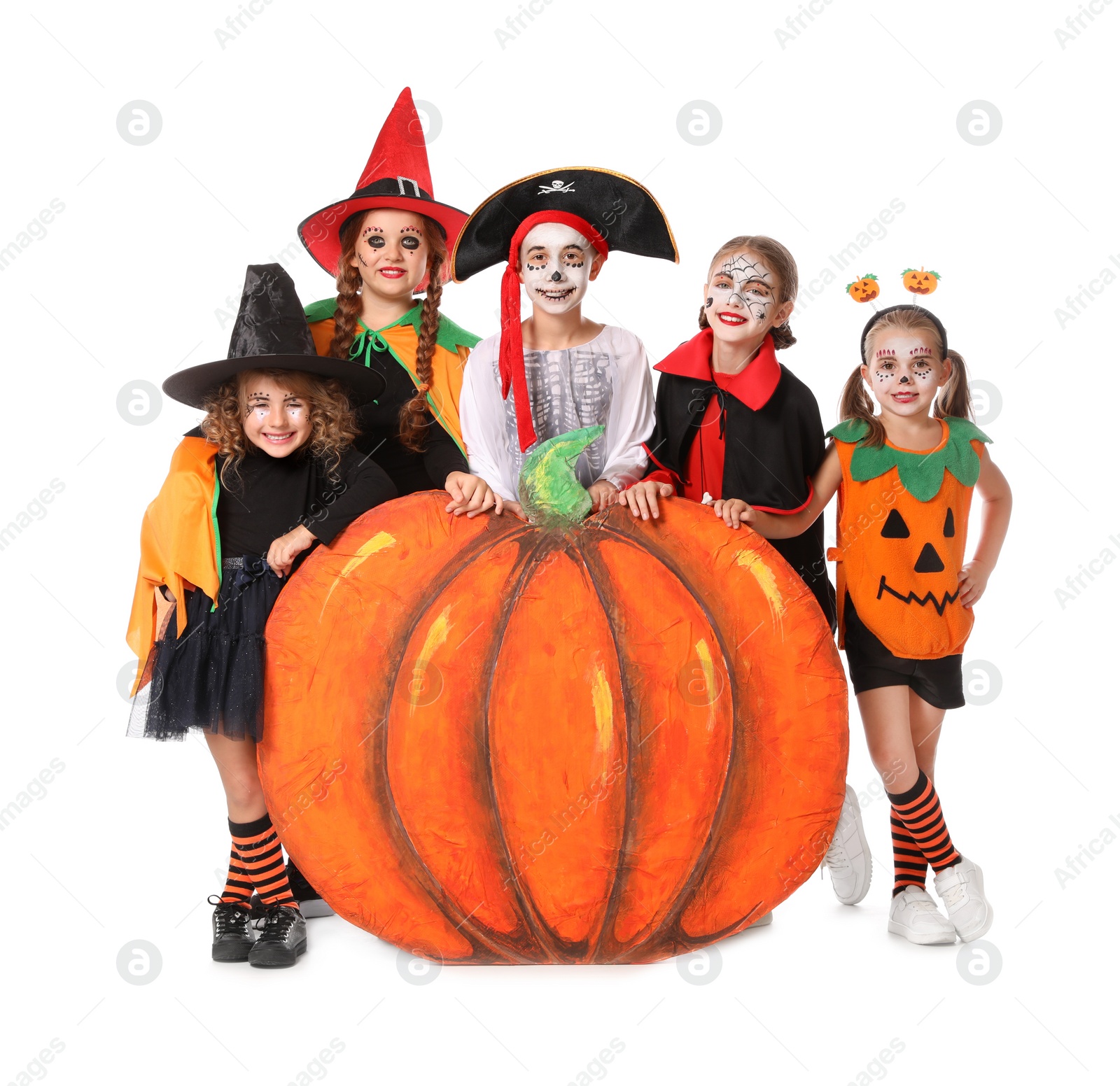 Photo of Cute little kids with decorative pumpkin wearing Halloween costumes on white background