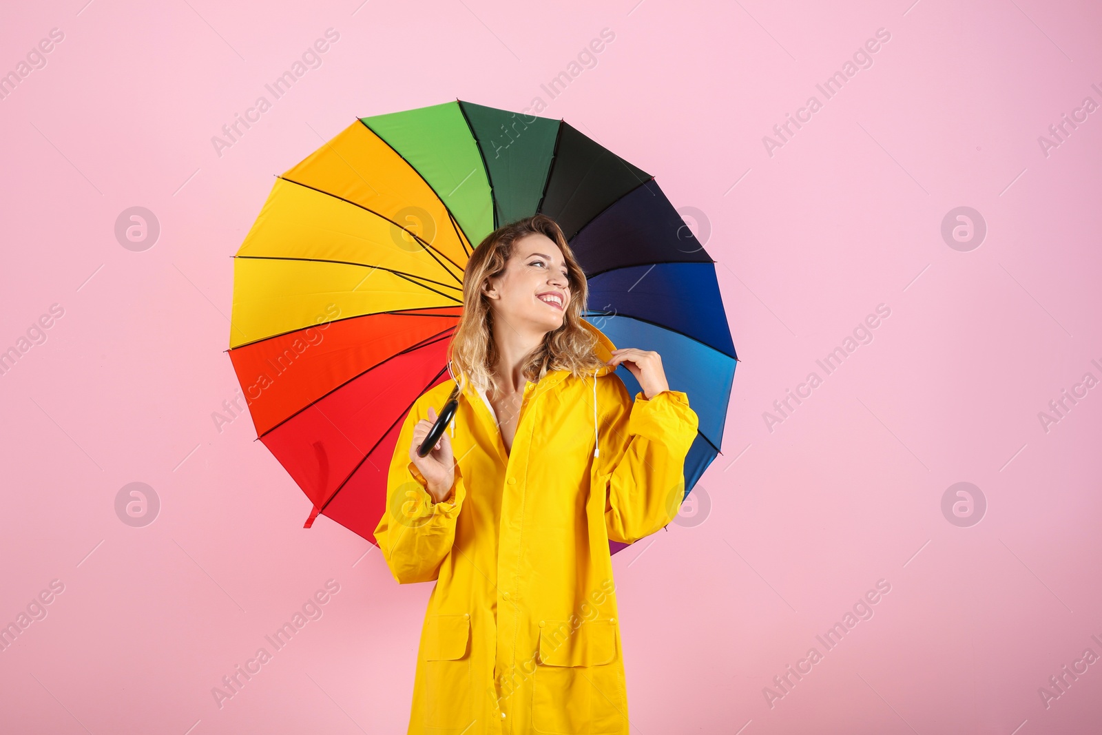 Photo of Woman with rainbow umbrella on color background