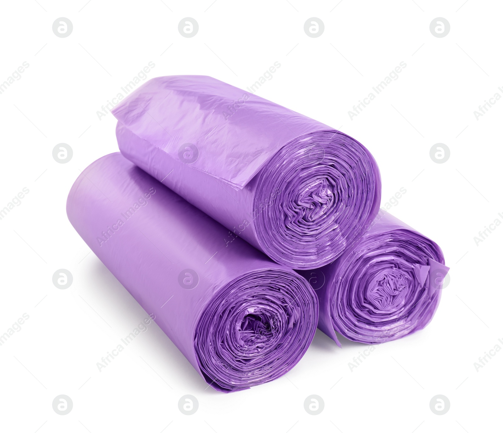 Photo of Rolls of violet garbage bags on white background. Cleaning supplies