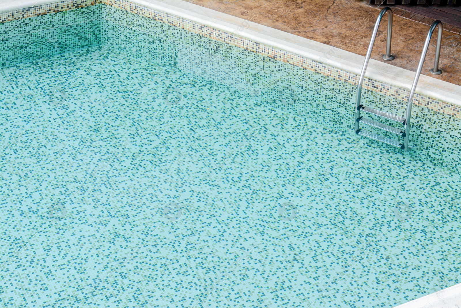 Photo of Ladder with grab bars in outdoor swimming pool