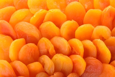 Tasty apricots as background, closeup. Dried fruit as healthy food