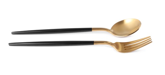 Photo of New golden fork and spoon with black handles on white background