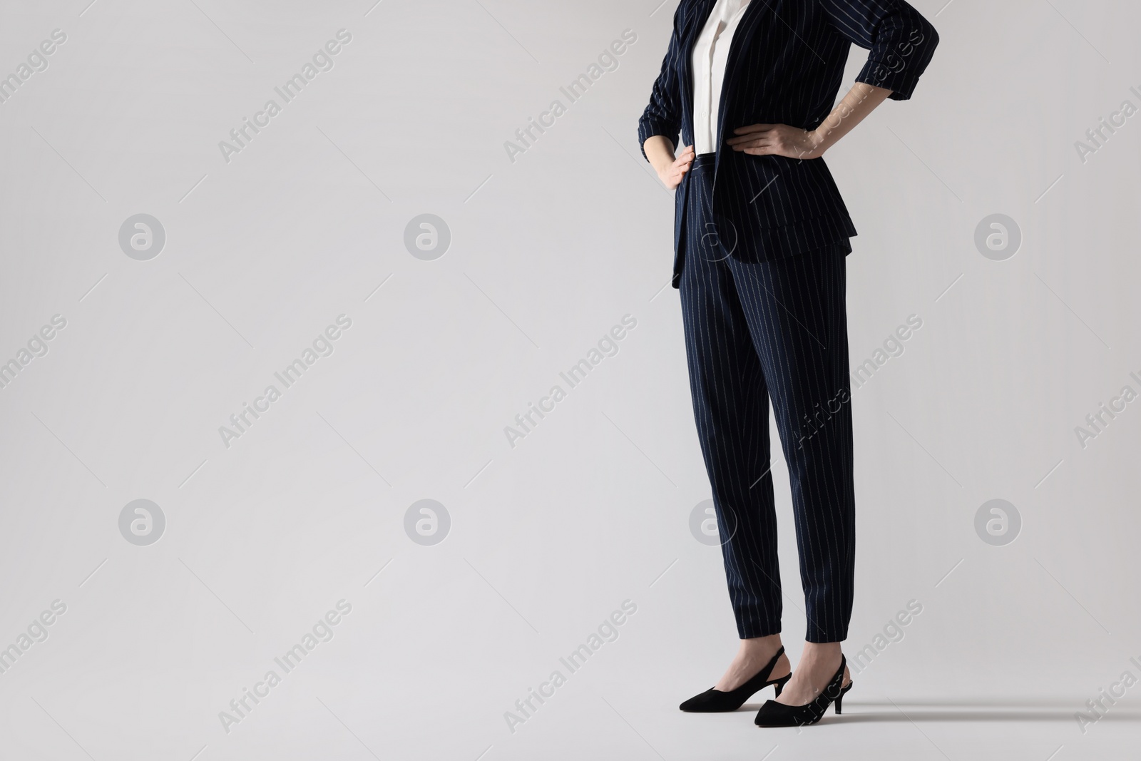 Photo of Businesswoman in black shoes on white background, closeup