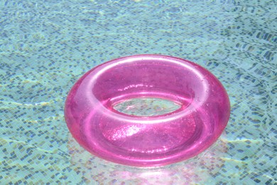 Inflatable ring floating on water in swimming pool