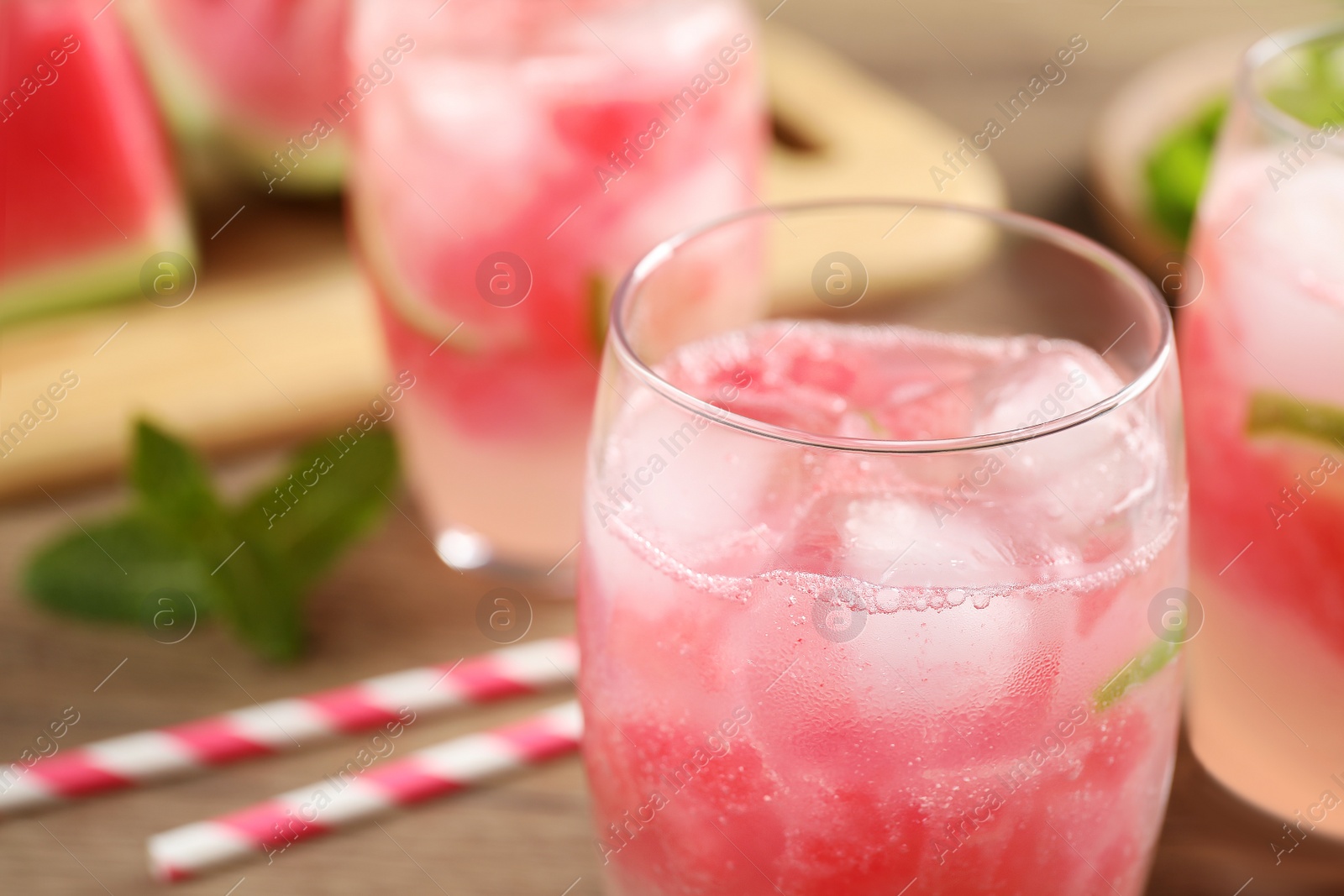 Photo of Delicious refreshing watermelon drink on wooden table, closeup