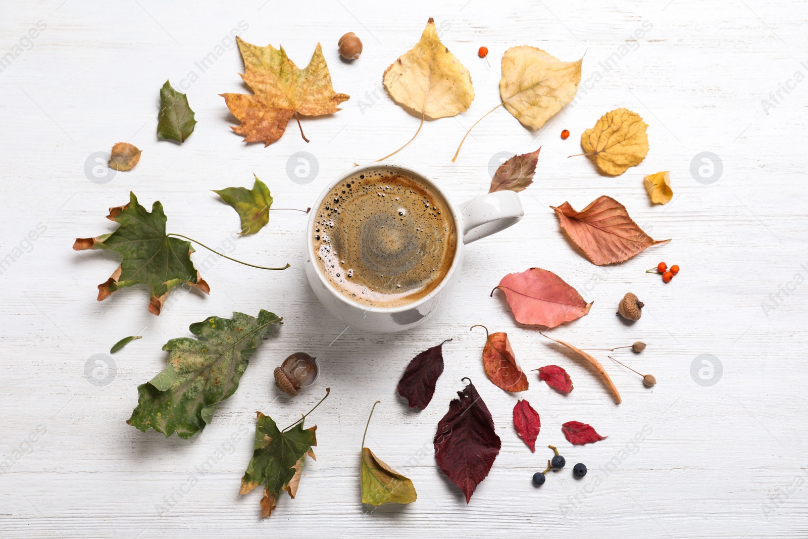 Photo of Flat lay composition with cup of hot drink on white wooden table. Cozy autumn atmosphere