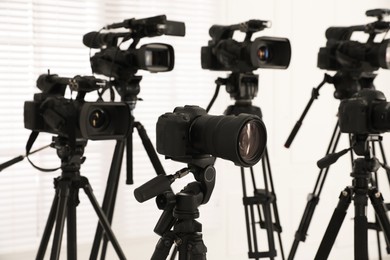 Photo of Modern video cameras indoors. Professional media equipment for broadcasting event