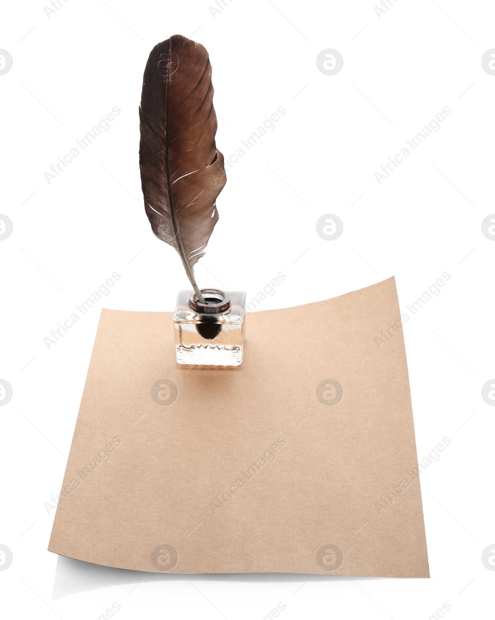 Photo of Feather pen with inkwell and blank paper on white background. Space for text