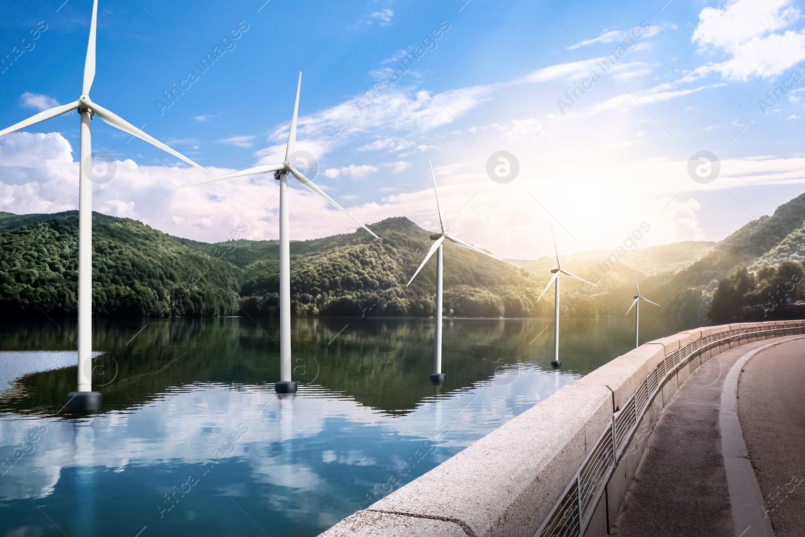 Image of Floating wind turbines installed in water near mountains. Alternative energy source