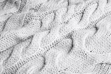 Photo of Grey knitted sweater as background, closeup view