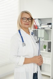 Photo of Professional doctor in uniform with stethoscope in clinic