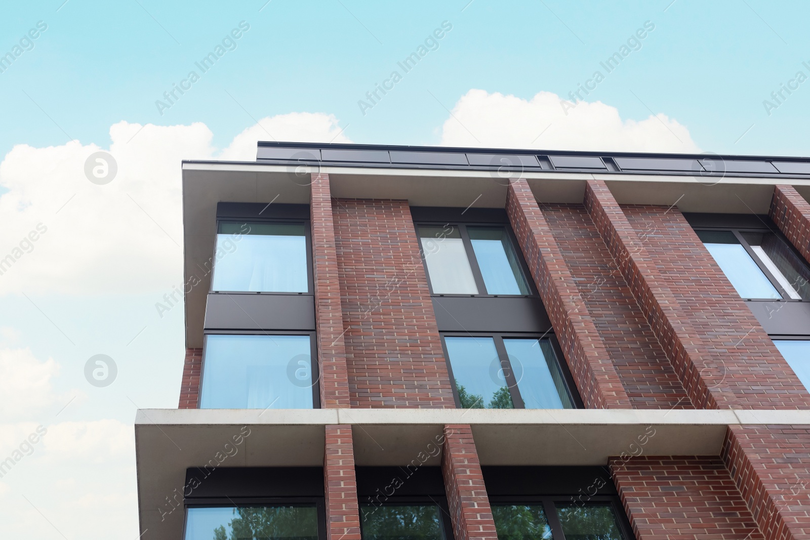 Photo of Beautiful modern building against cloudy sky, low angle view