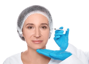 Mature woman getting facial injection on white background. Cosmetic surgery concept