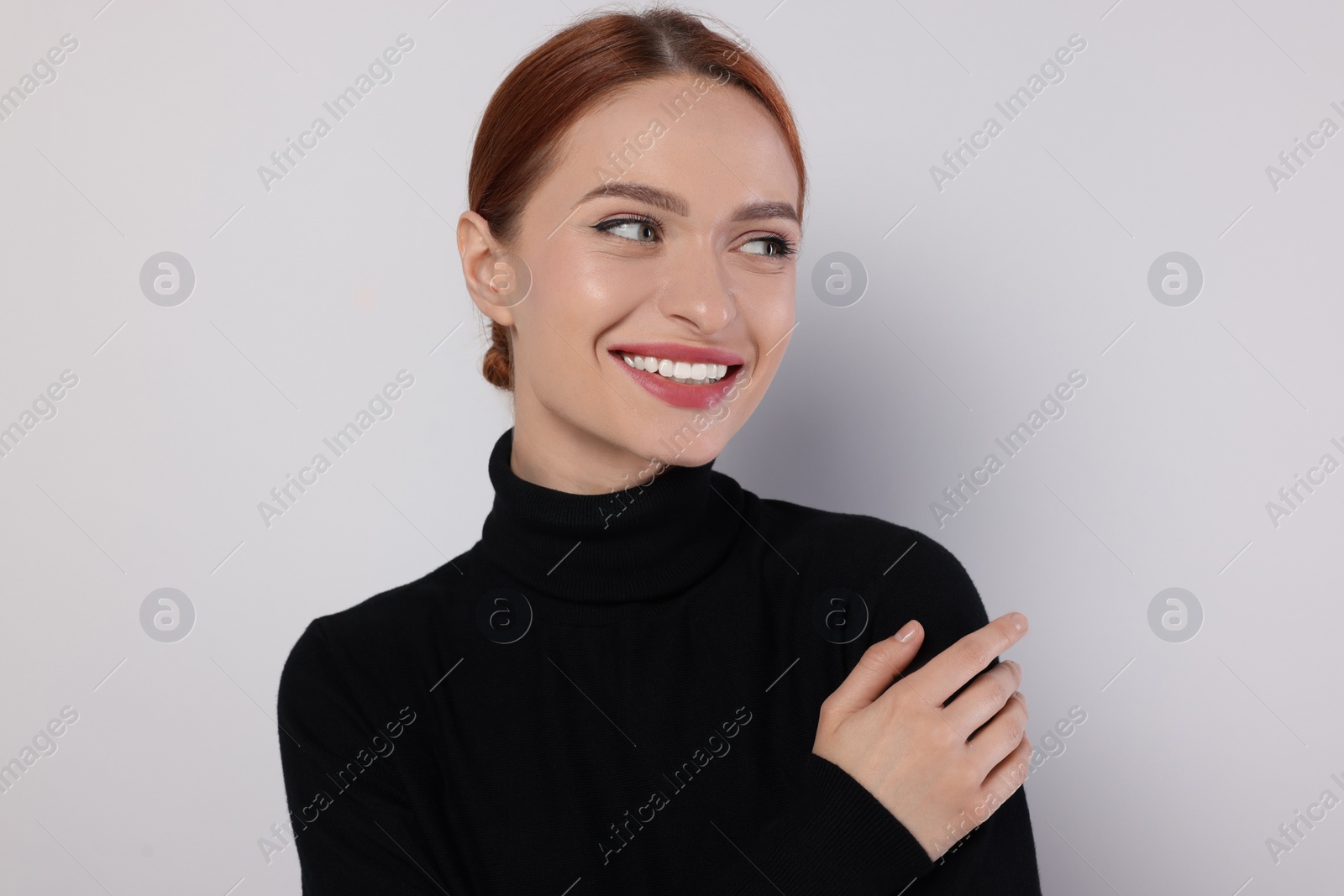 Photo of Portrait of beautiful young woman on light gray background