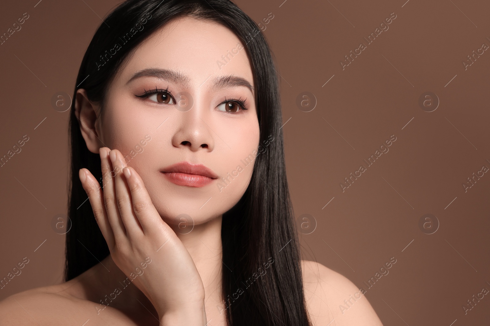 Photo of Portrait of beautiful woman on brown background, space for text