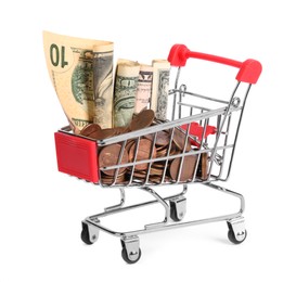 Photo of Small metal shopping cart with dollar bills and coins isolated on white