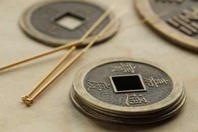 Photo of Acupuncture needles and Chinese coins on paper, closeup