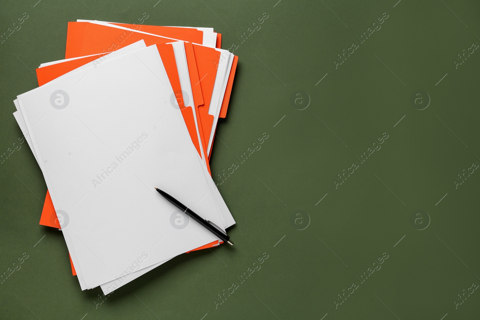 Photo of Orange files with blank sheets of paper and pen on dark green background, top view. Space for text