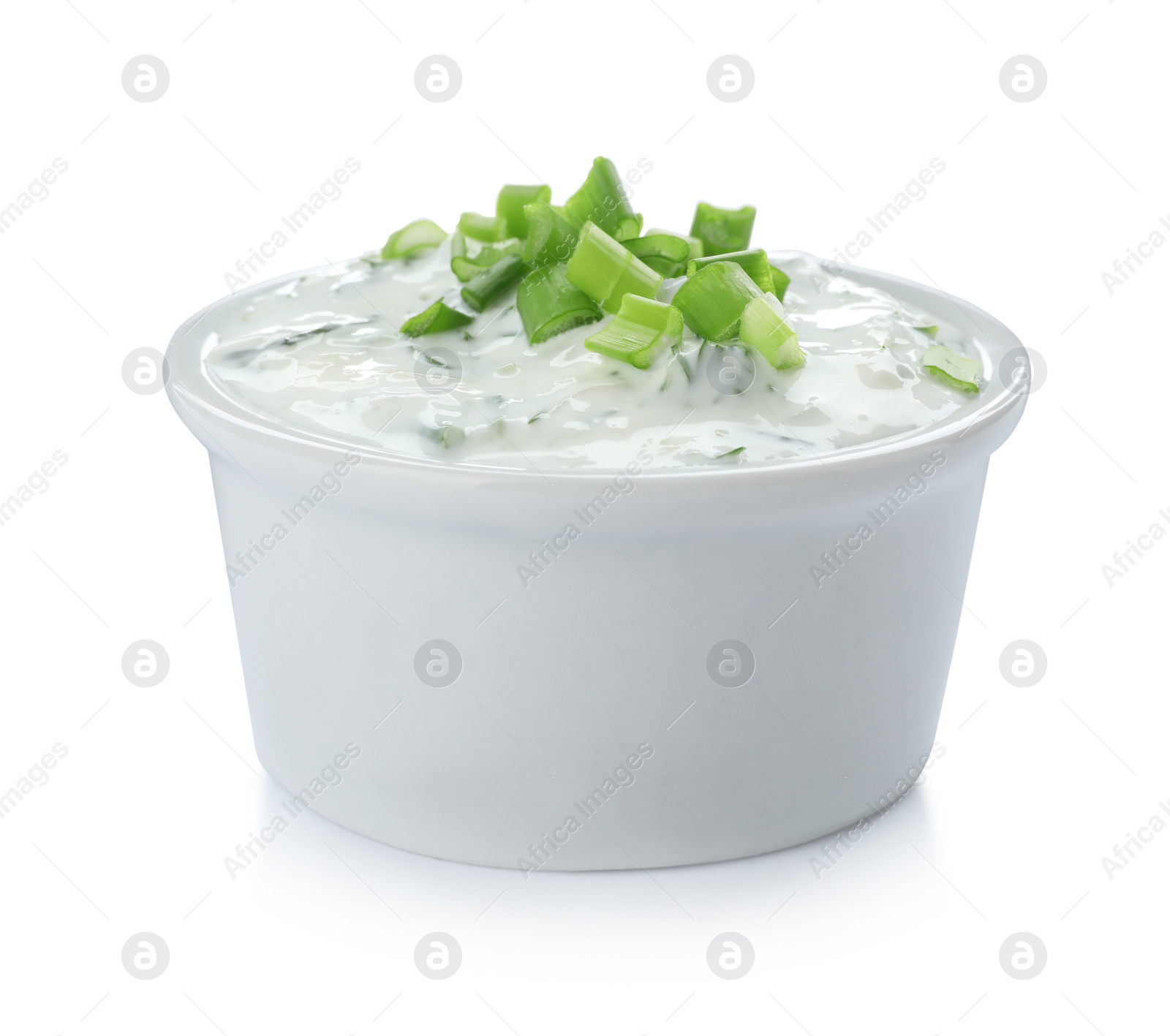 Photo of Bowl with cucumber sauce on white background