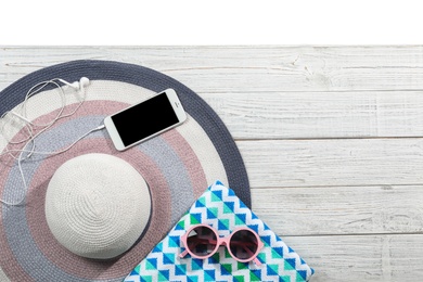 Photo of Flat lay composition with beach accessories on wooden background. Space for text