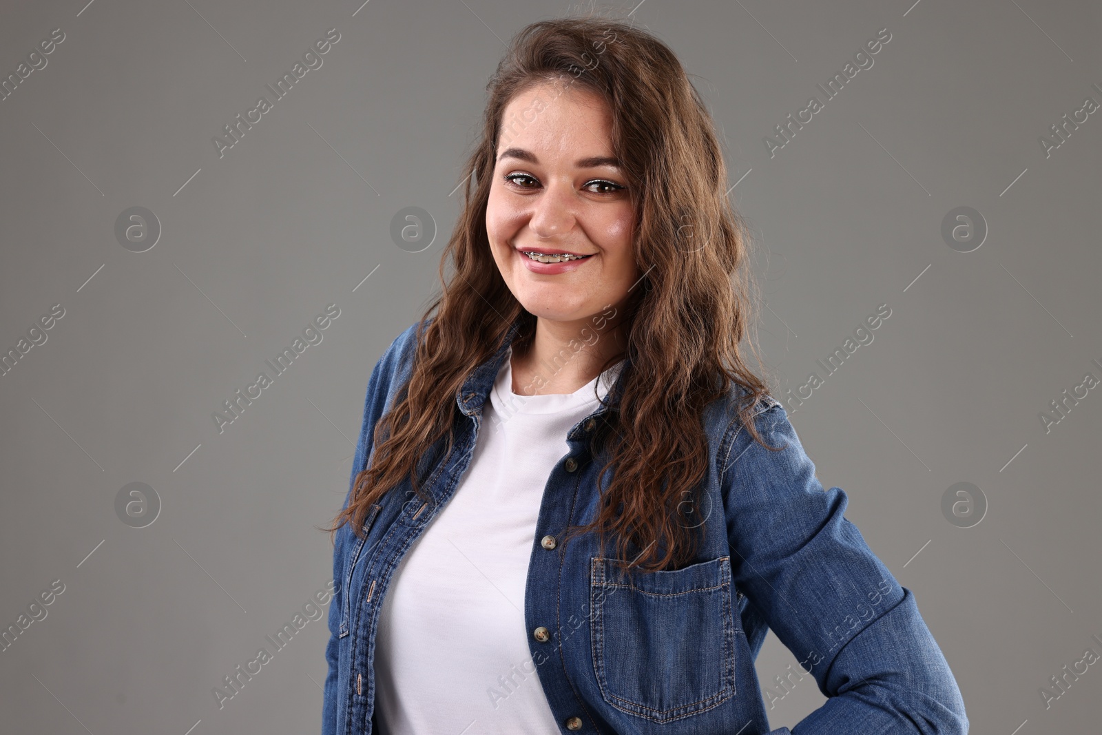 Photo of Portrait of beautiful young woman on grey background