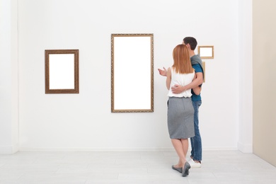 Couple viewing exposition in modern art gallery