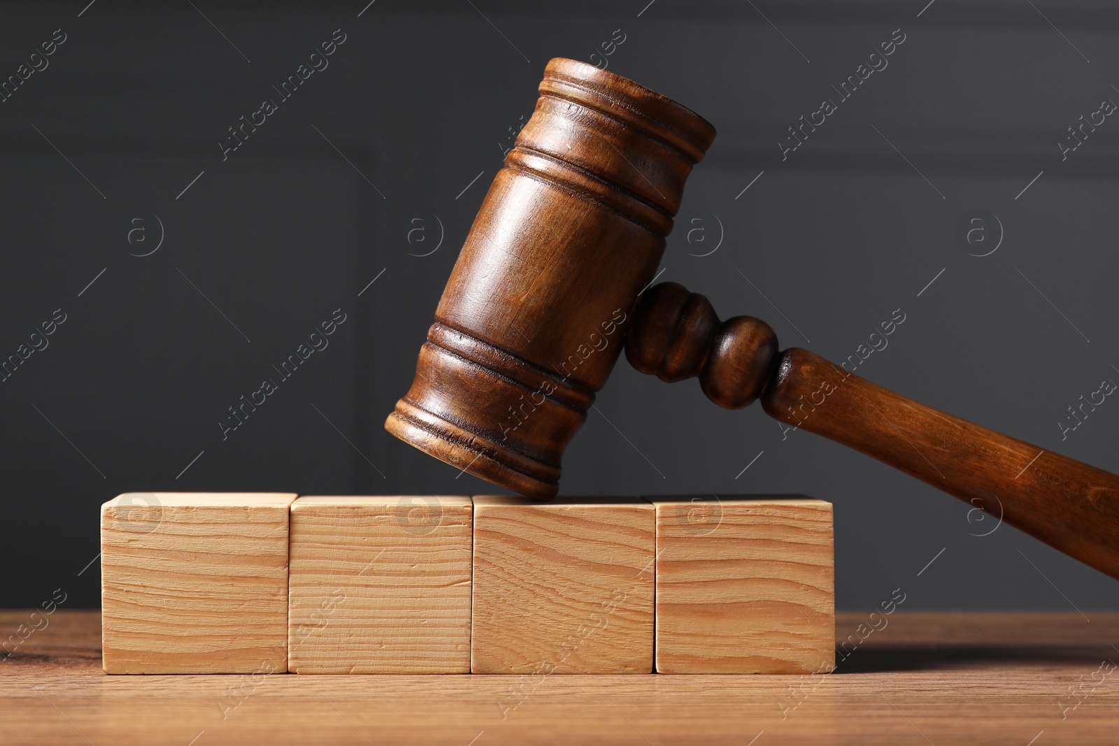 Photo of Law. Blank wooden cubes and gavel on table