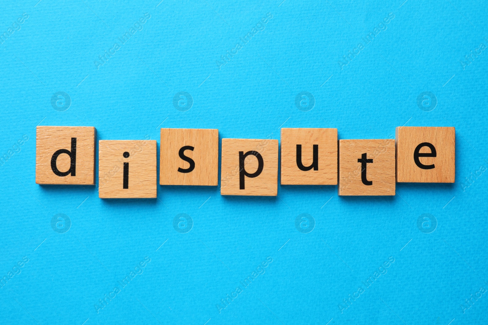 Photo of Word Dispute made with wooden cubes on light blue background, top view