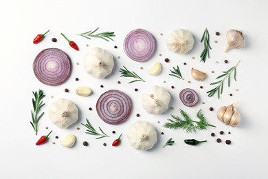 Composition with garlic, peppers and onion on white background, top view