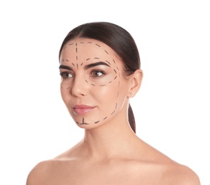Photo of Young woman with marks on face for cosmetic surgery operation against white background