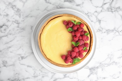 Photo of Dessert plate with delicious raspberry cake on marble table, top view