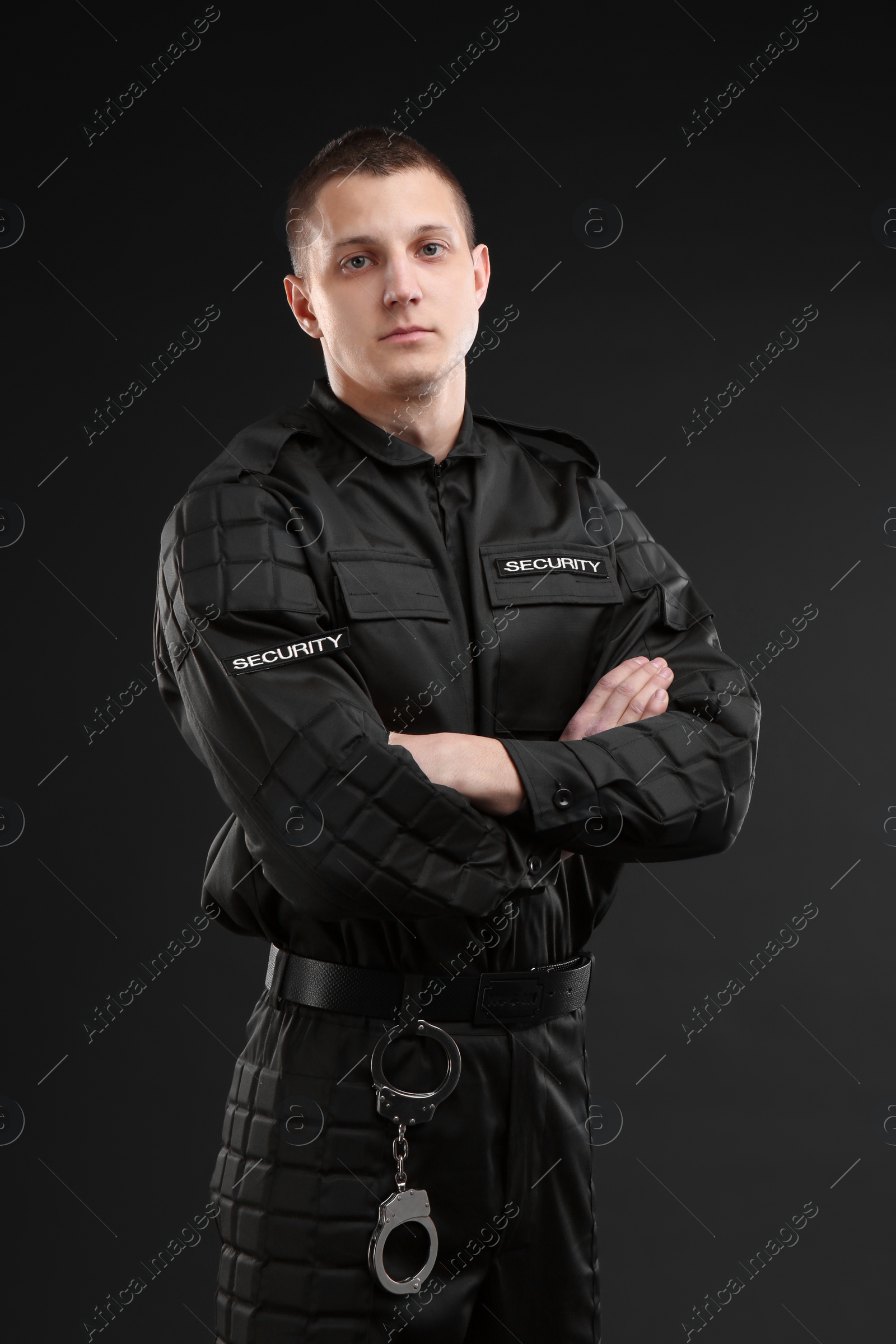 Photo of Male security guard in uniform on dark background