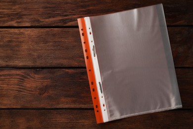 File folder with punched pockets on wooden table, top view. Space for text