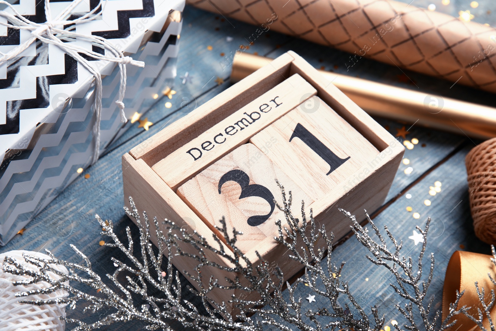 Photo of Wooden block calendar and festive decor on table, closeup