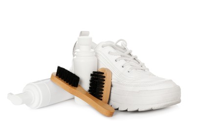 Composition with stylish footwear and shoe care accessories on white background
