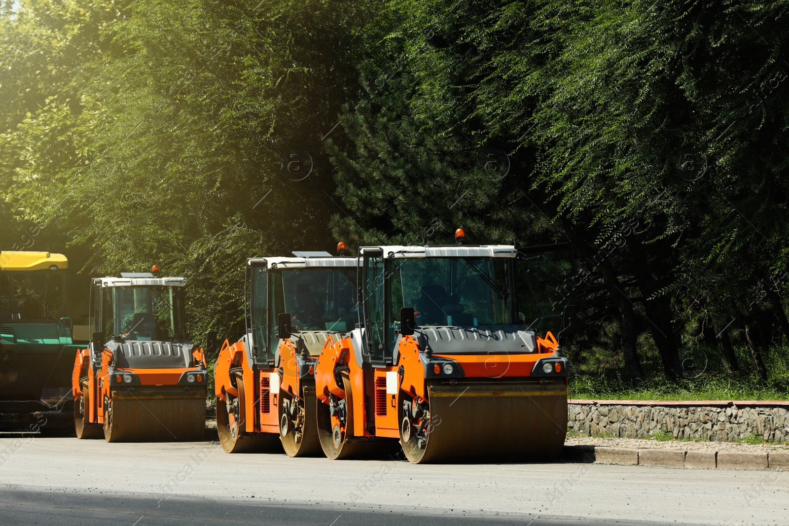 Photo of Modern rollers on city street. Road repair service