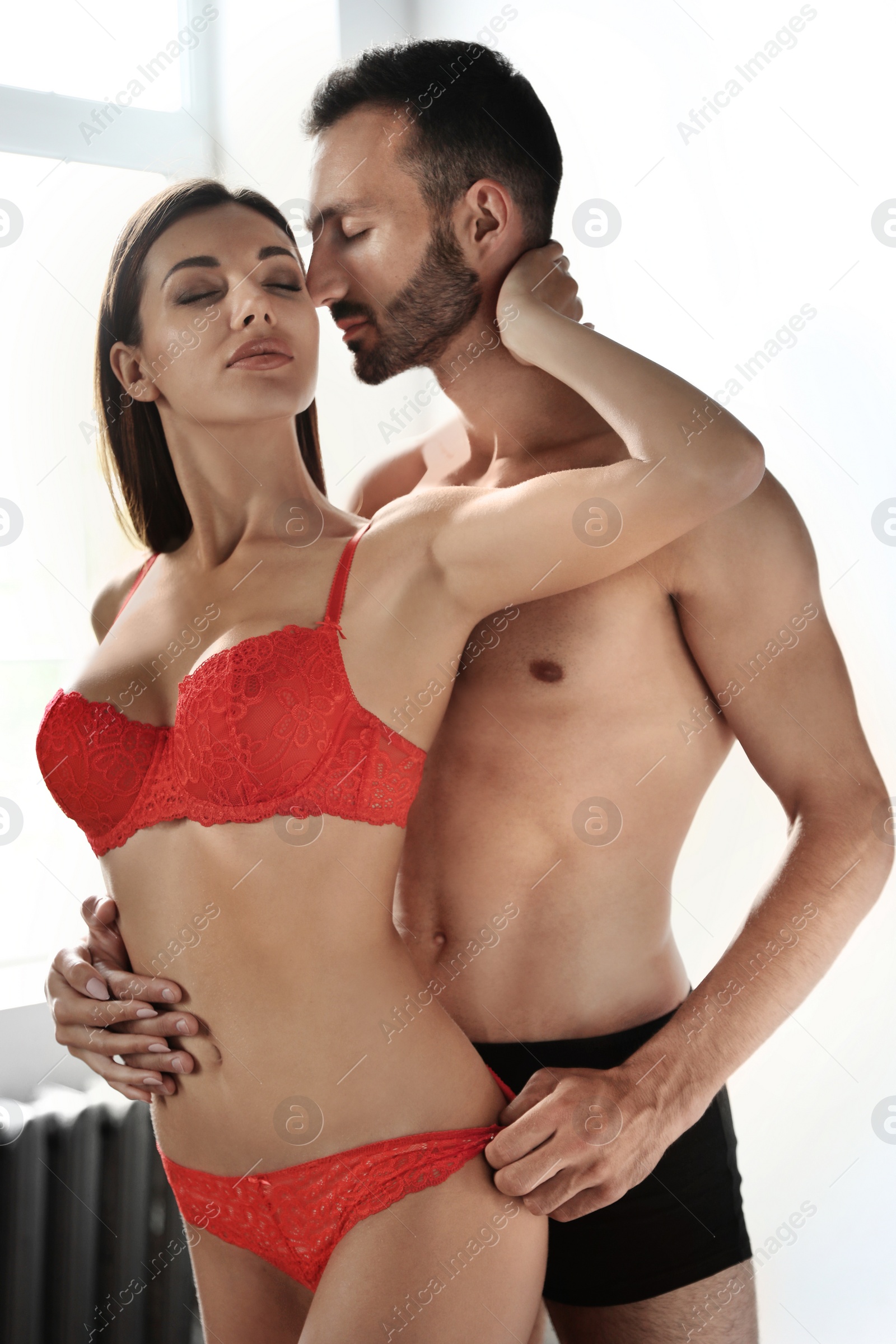 Photo of Passionate young couple being intimate at home. Sex foreplay