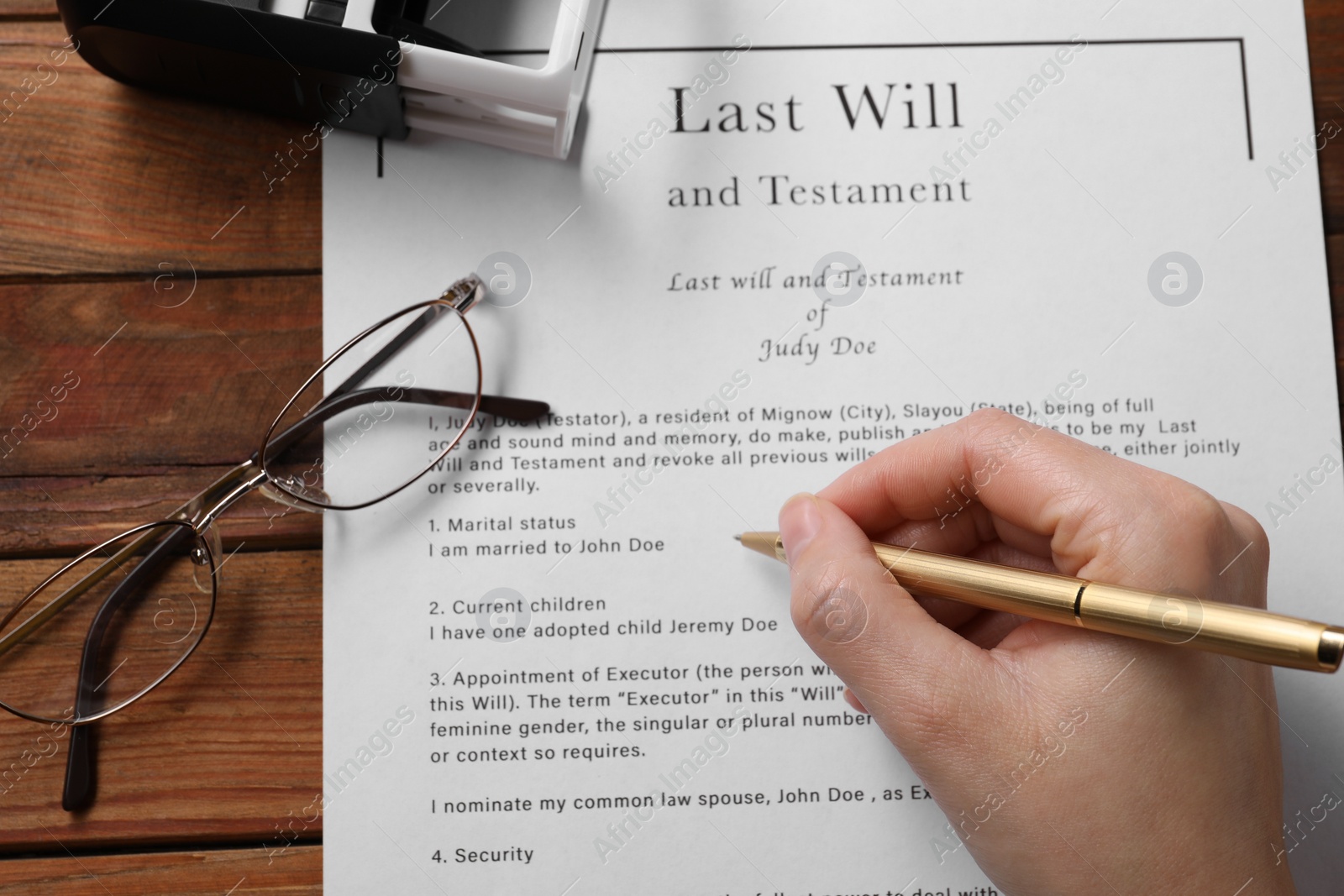 Photo of Woman signing Last Will and Testament at wooden table, above view